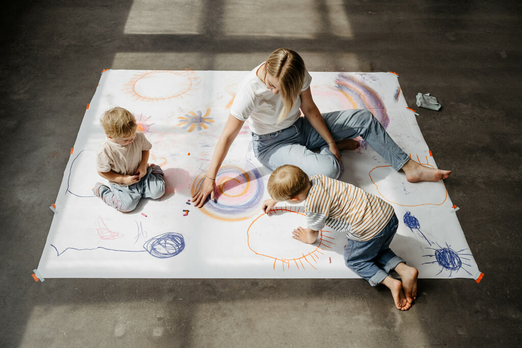 Kunsttherapeutin malt mit Kindern